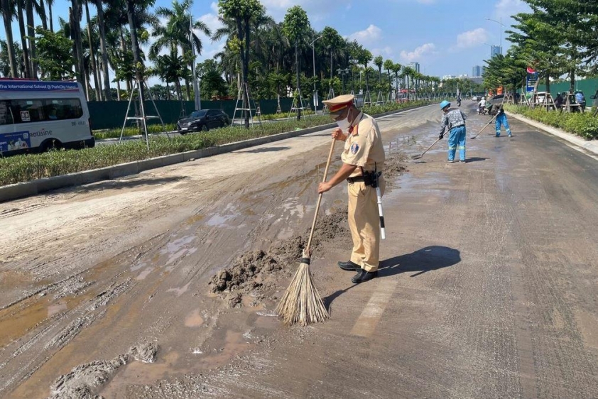 Lực lượng chức năng khắc phục mặt đường bị dầu loang